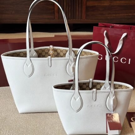 Double sided tote bag with one side made of premium grain leather and the other side made of classic GG canvas